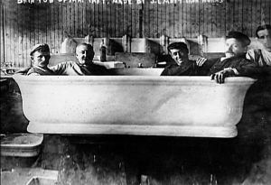 Workers sitting in Taft bathtub before installation.